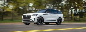 A Lincoln Aviator Black Label driving down a road